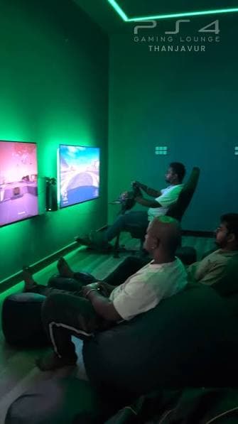 Gamers seated in the lounge with green ambient lighting